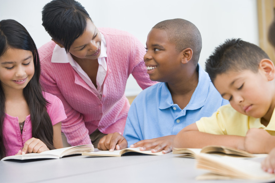 Photo of a teacher working with an elementary school reading group