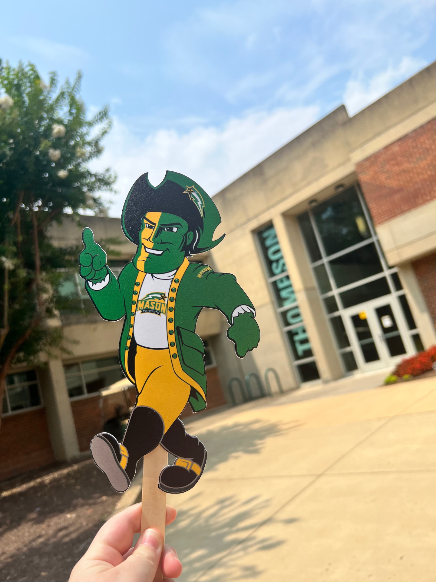 Flat Patriot walking out of Thompson Hall