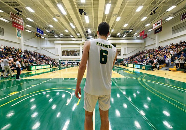 Photograph of Sam Greenslade from behind at a volleyball game