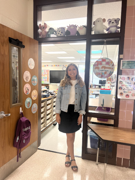 Photograph of Leslie Muñoz standing in her classroom door