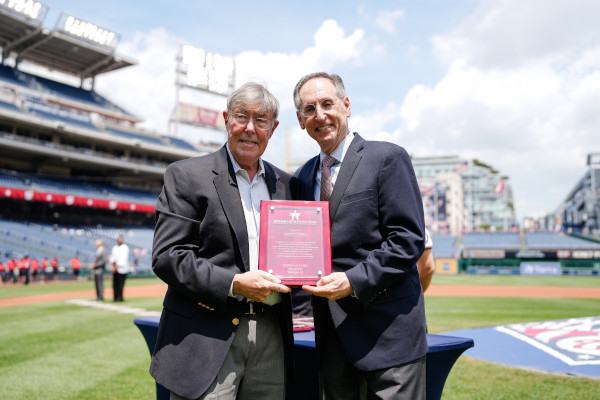 Charley Casserly accepts a plaque commemorating his induction into the Washington DC Sports Hall of Fame.