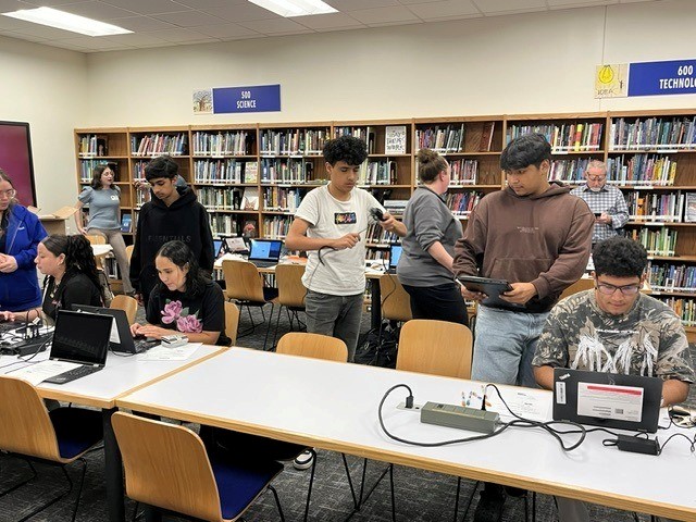 Students working with laptops in a library