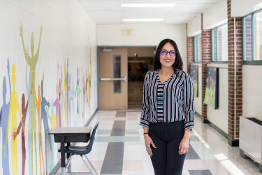 Photo of Dr. Liza Burrell-Aldana standing in the hallway of Mount Vernon Community School