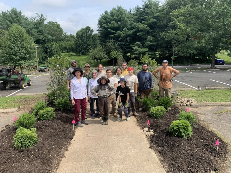 Thomas Bardroff and others posing together after working on a garden area
